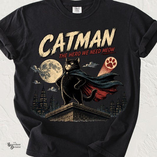 Vintage superhero-style black cat wearing a cape on a rooftop under a full moon with the words "Catman – The Hero We Need Meow."