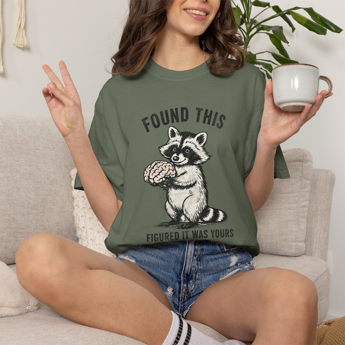 Found This Raccoon Holding Brain T-Shirt — "FOUND THIS / FIGURED IT WAS YOURS"
