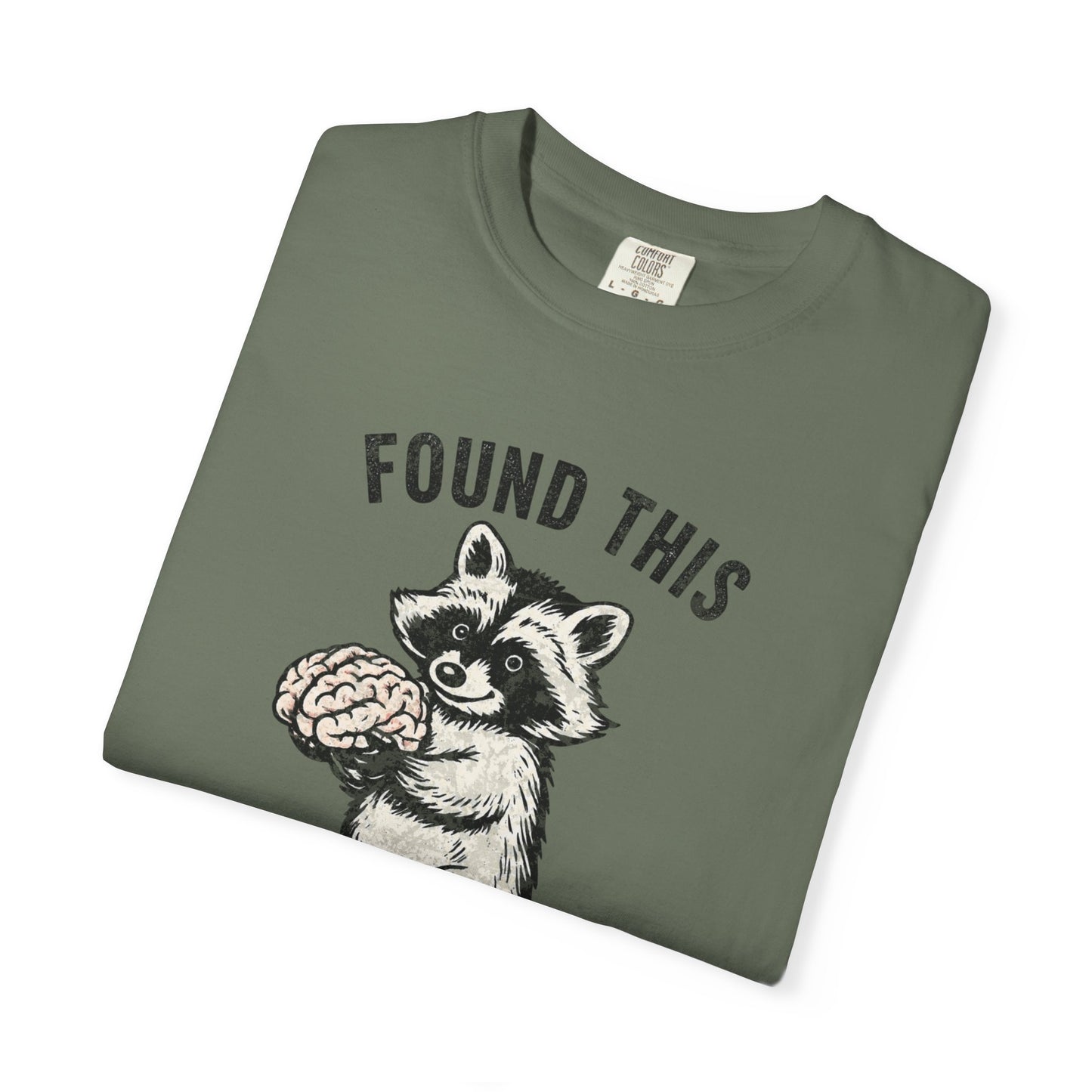 Found This Raccoon Holding Brain T-Shirt — "FOUND THIS / FIGURED IT WAS YOURS"