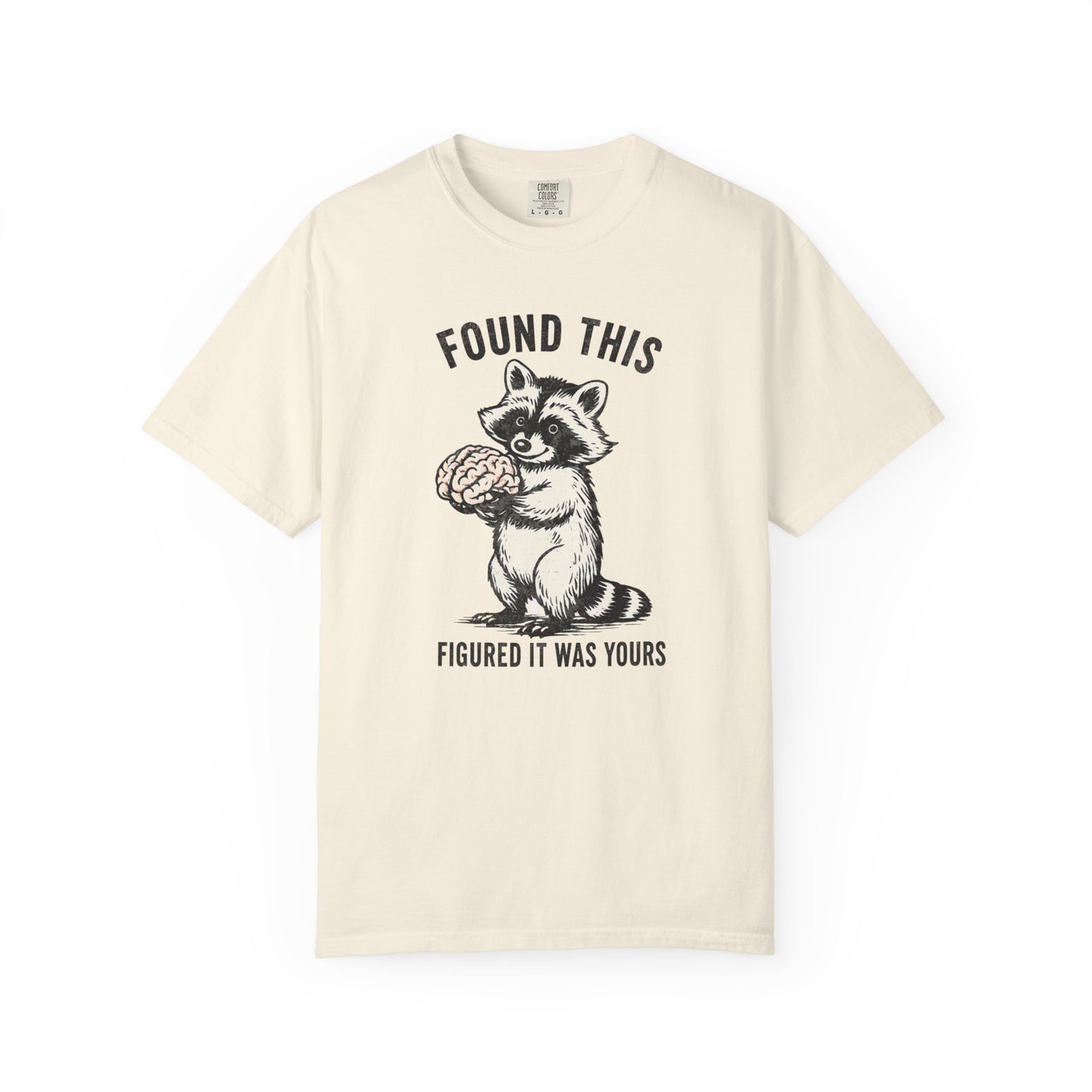 Found This Raccoon Holding Brain T-Shirt — "FOUND THIS / FIGURED IT WAS YOURS"