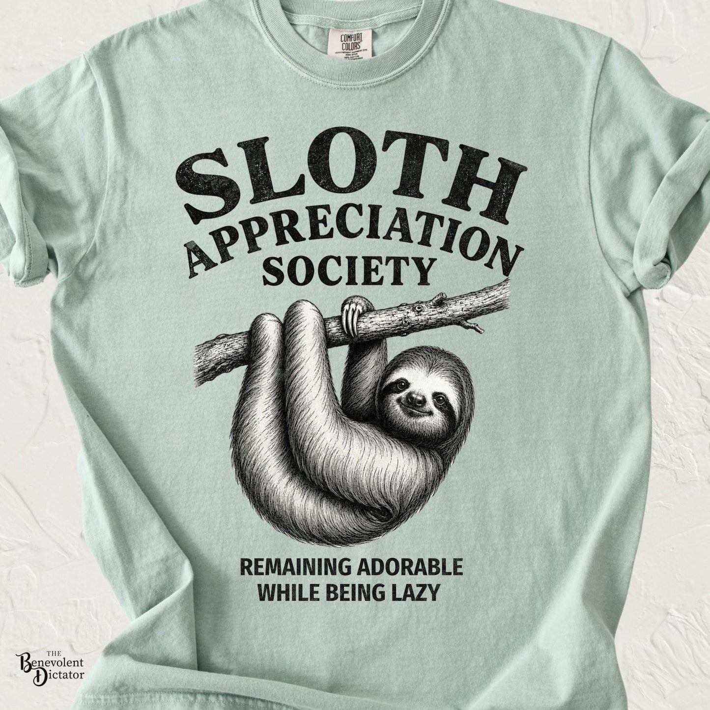 Vintage-inspired sloth hanging from a tree branch with the text "Sloth Appreciation Society" and "Remaining Adorable While Being Lazy."