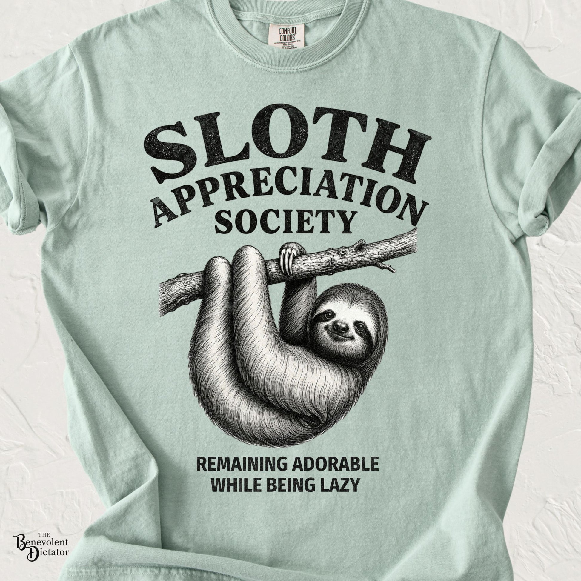 Vintage-inspired sloth hanging from a tree branch with the text "Sloth Appreciation Society" and "Remaining Adorable While Being Lazy."