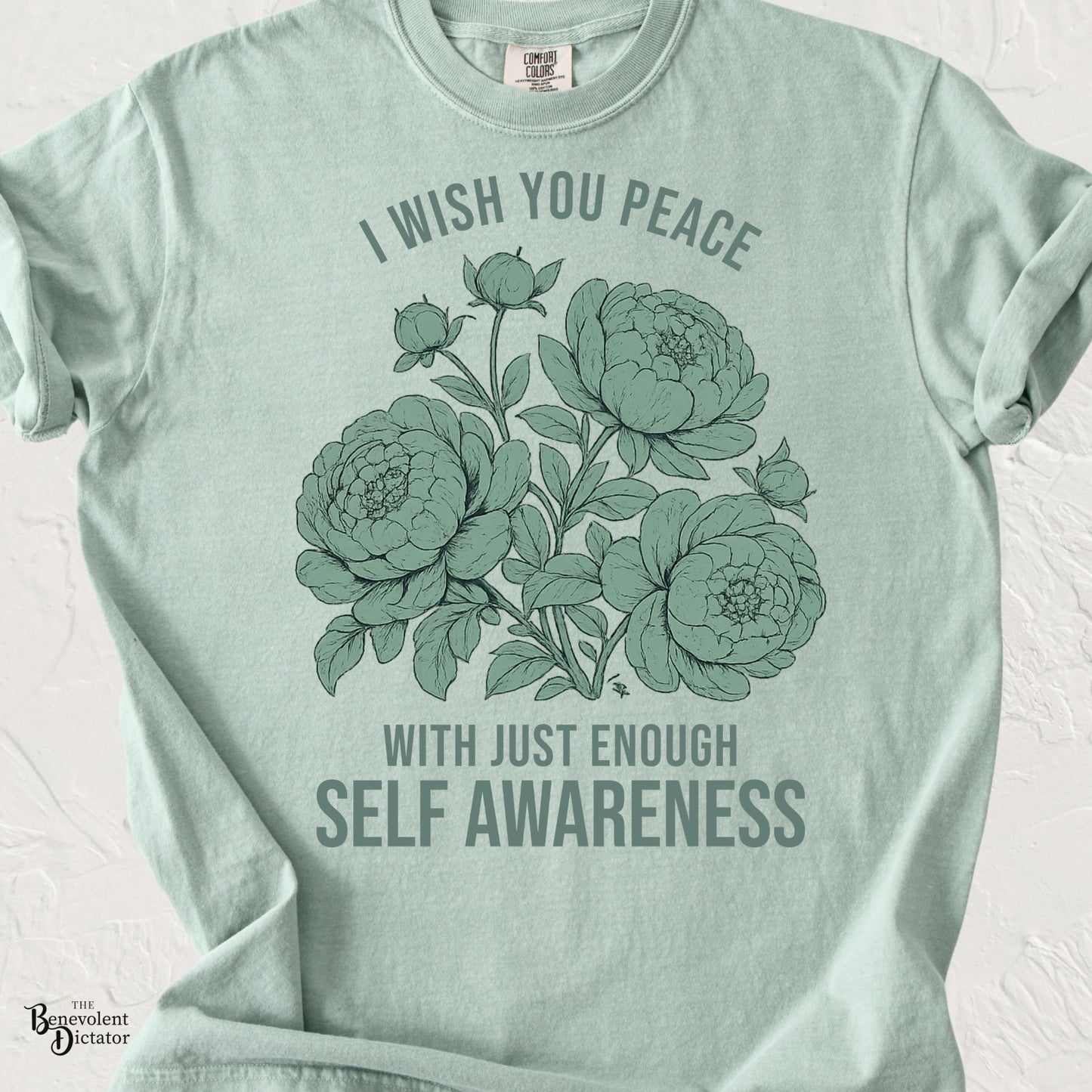 Vintage floral graphic featuring peonies with the phrase "I Wish You Peace With Just Enough Self Awareness" printed in muted sage green on a Comfort Colors® t-shirt.