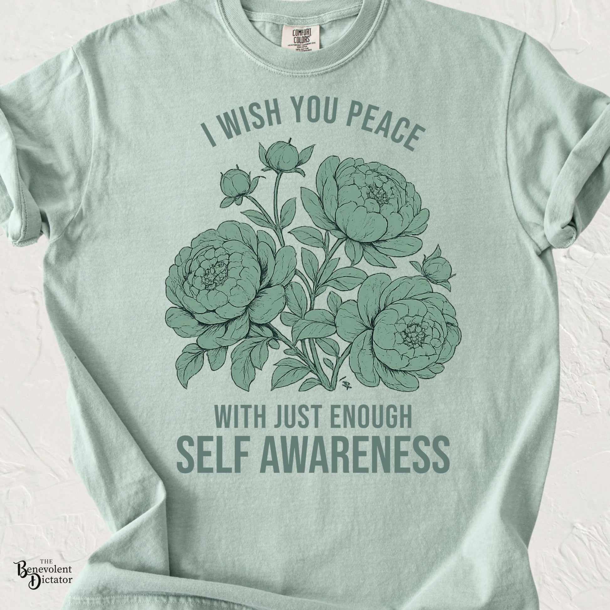 Vintage floral graphic featuring peonies with the phrase "I Wish You Peace With Just Enough Self Awareness" printed in muted sage green on a Comfort Colors® t-shirt.