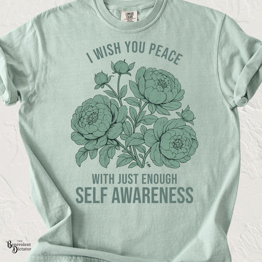 Vintage floral graphic featuring peonies with the phrase "I Wish You Peace With Just Enough Self Awareness" printed in muted sage green on a Comfort Colors® t-shirt.