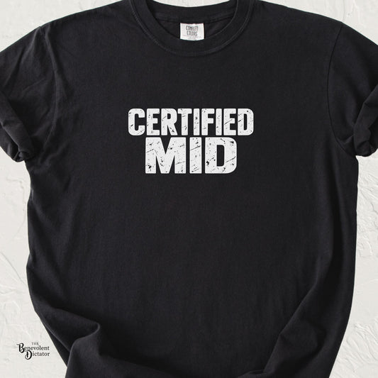 Black Comfort Colors t-shirt with bold distressed white typography reading “Certified MID” in a simple minimalist graphic design.