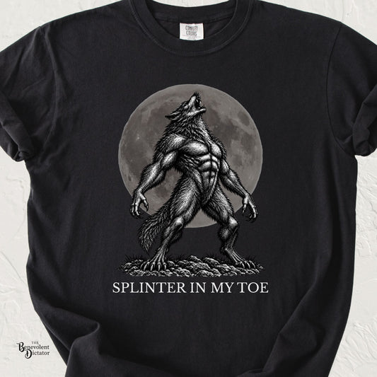 Black Comfort Colors t-shirt featuring a muscular werewolf howling dramatically in front of a full moon with the words “Splinter in My Toe.”