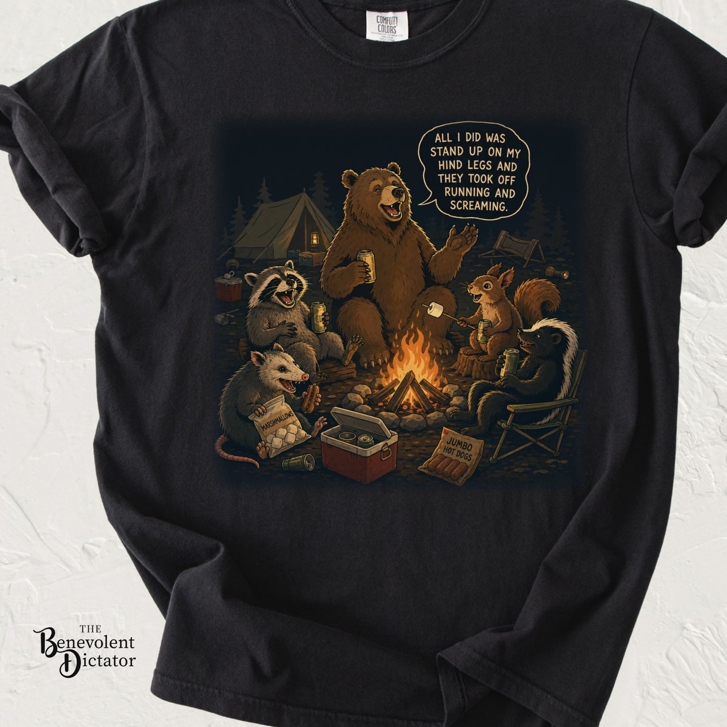 Funny camping graphic t-shirt featuring woodland animals around a campfire with a bear telling a story about how he 'stole' all the campers food