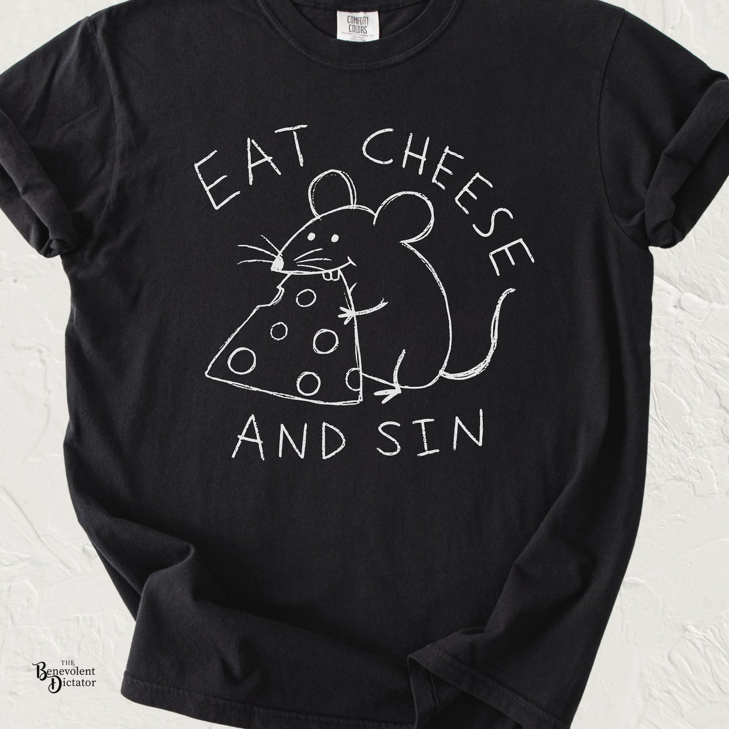 Black graphic t-shirt featuring childlike hand-drawn text reading “Eat Cheese and Sin” with a doodle mouse hugging and eating a wedge of cheese.