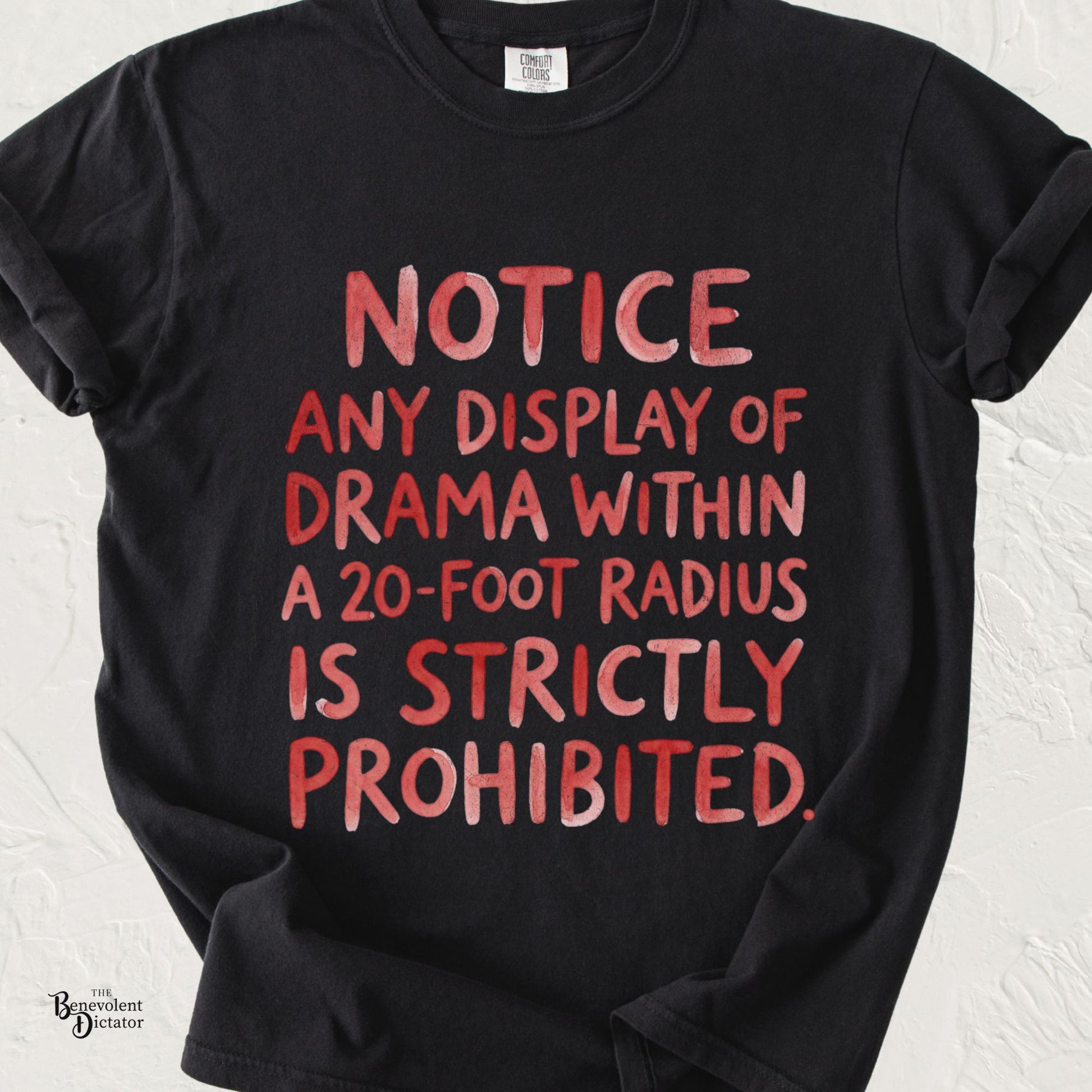 Black Comfort Colors t-shirt featuring bold distressed red typography reading: "NOTICE: Any display of drama within a 20-foot radius is strictly prohibited."