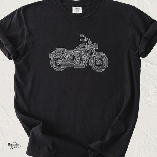 Black Comfort Colors t-shirt featuring a minimalist parallel-line illustration of a classic cruiser motorcycle in clean white line art.