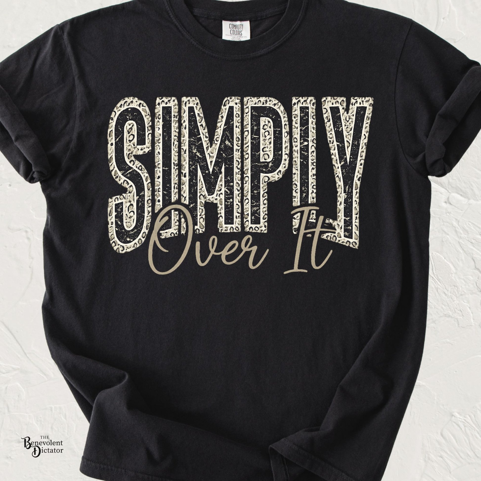 Vintage distressed typography reading "Simply Over It" with leopard print accents and script lettering on a Comfort Colors® t-shirt.