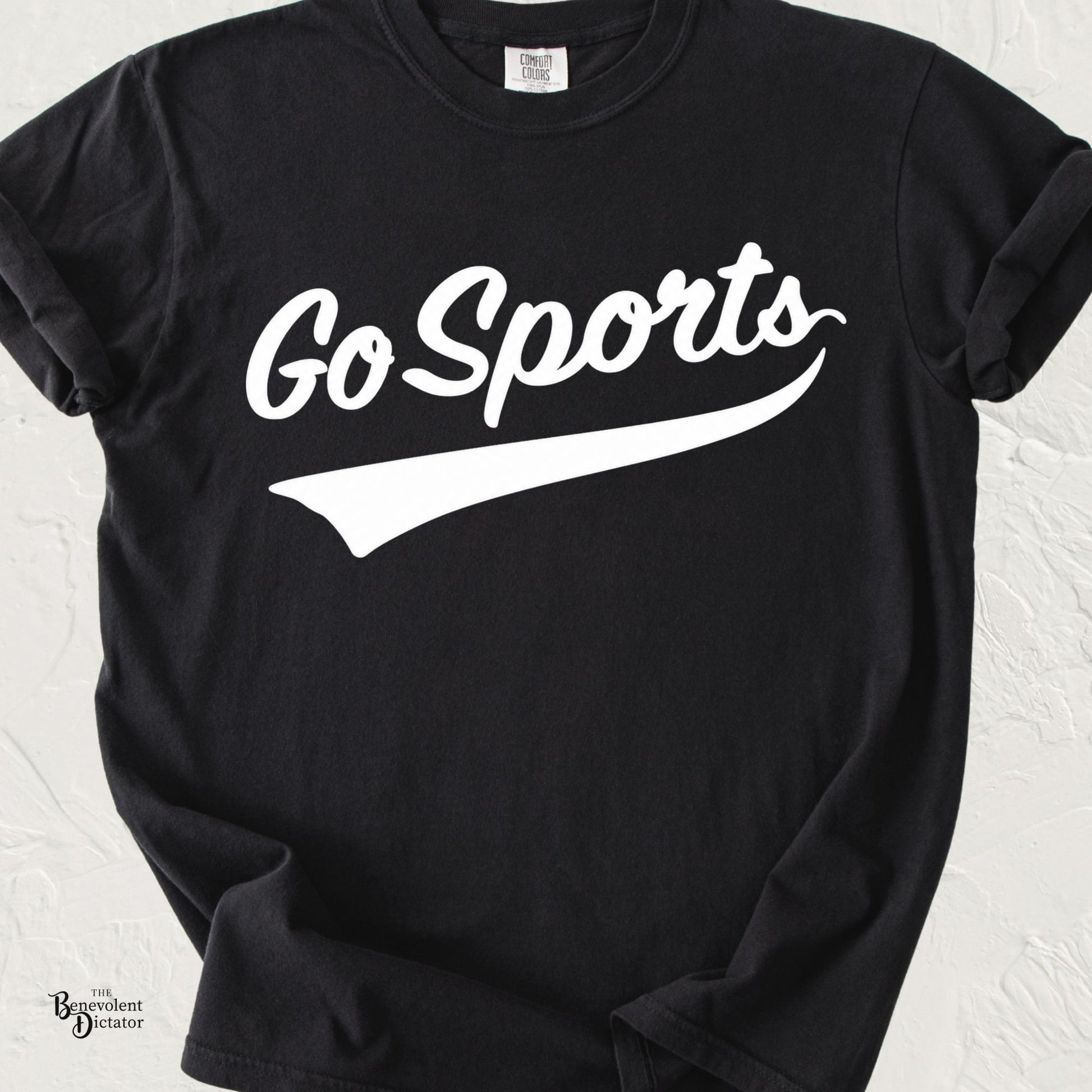 Minimalist typography t-shirt featuring the phrase "Go Sports" in vintage-inspired script with a swoosh underline on a Comfort Colors® tee.
