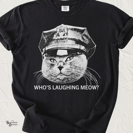 Vintage black-and-white grumpy cat wearing a police officer hat with the phrase "Who's Laughing Meow?" on a Comfort Colors® t-shirt.