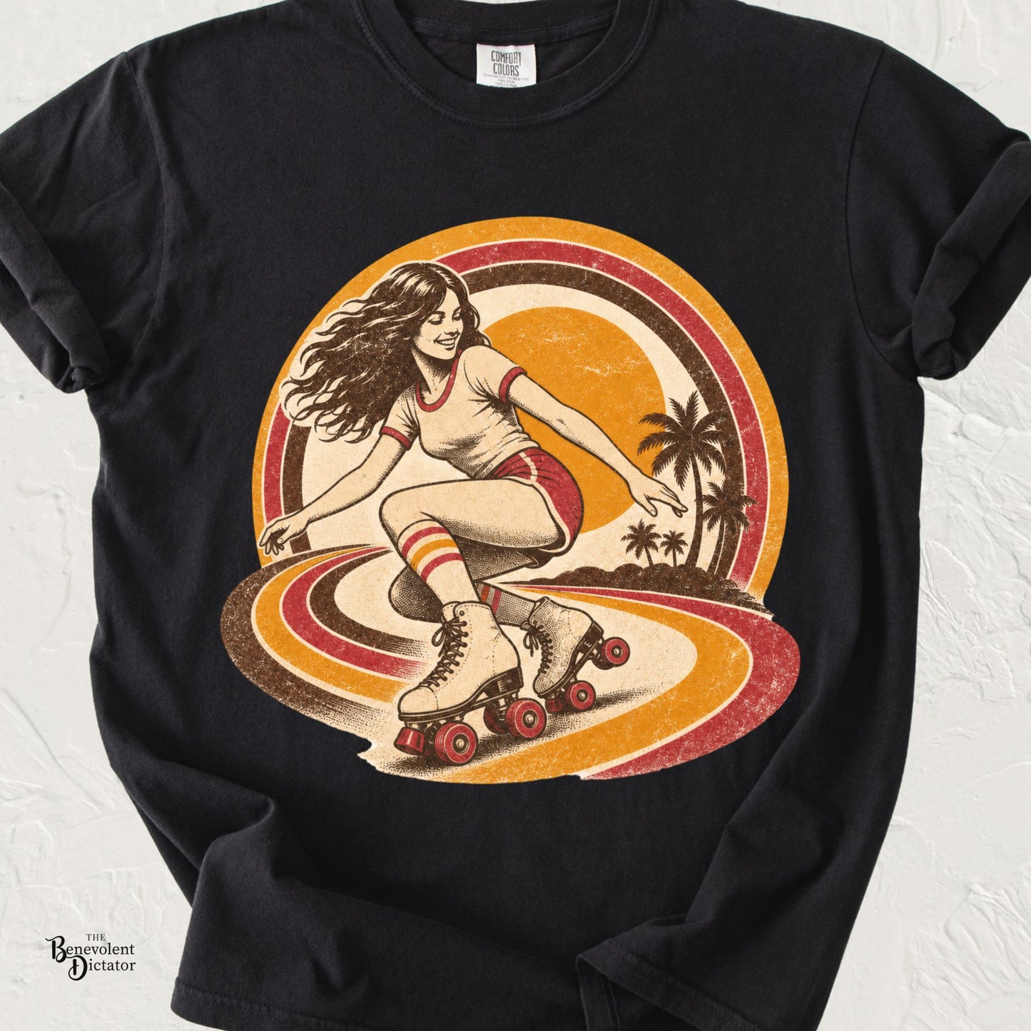 Vintage-inspired roller skating graphic featuring a woman on quad skates with retro sunset stripes and palm trees on a Comfort Colors® t-shirt.