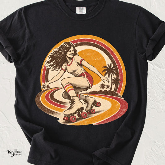 Vintage-inspired roller skating graphic featuring a woman on quad skates with retro sunset stripes and palm trees on a Comfort Colors® t-shirt.