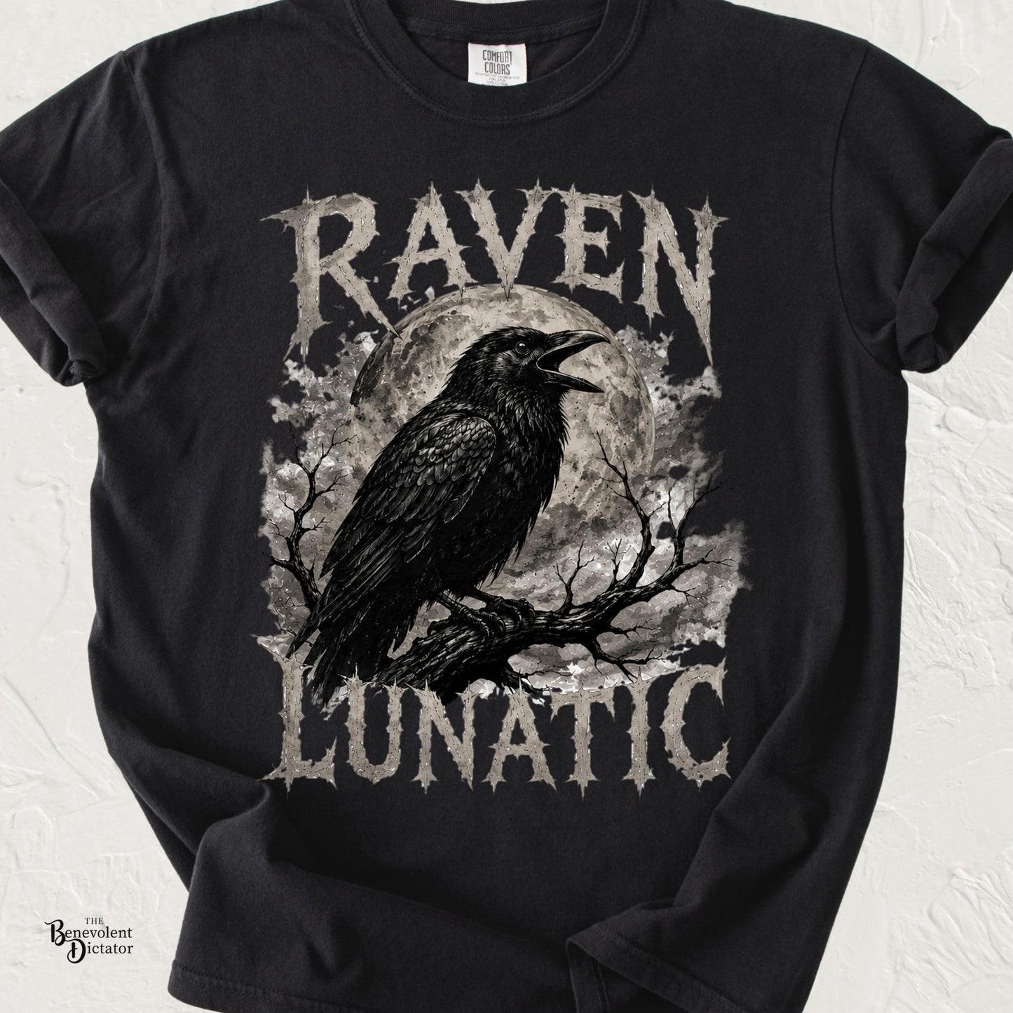 Black raven perched on a tree branch in front of a full moon with the words "Raven Lunatic" in distressed gothic lettering.