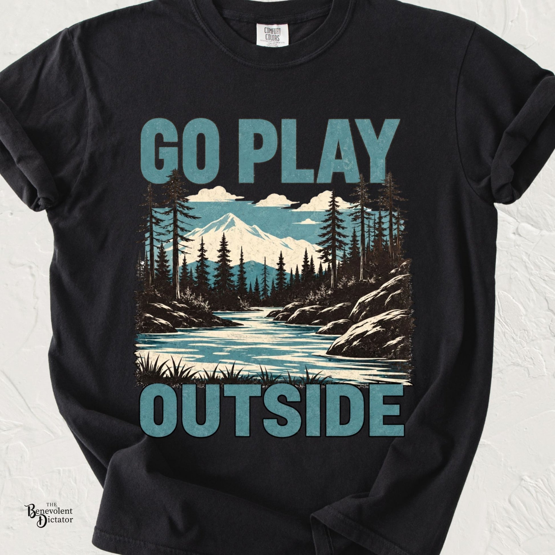 Vintage mountain landscape with river, pine forest, and bold blue typography reading "Go Play Outside" on a transparent background.