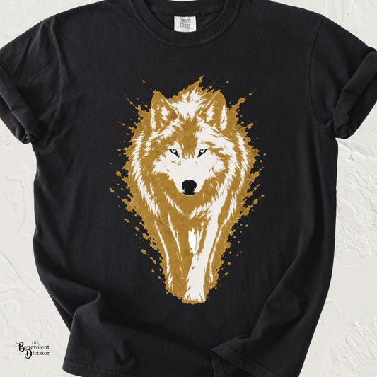 Vintage-style wolf graphic walking forward in golden tan and cream with distressed paint splashes on a transparent background.