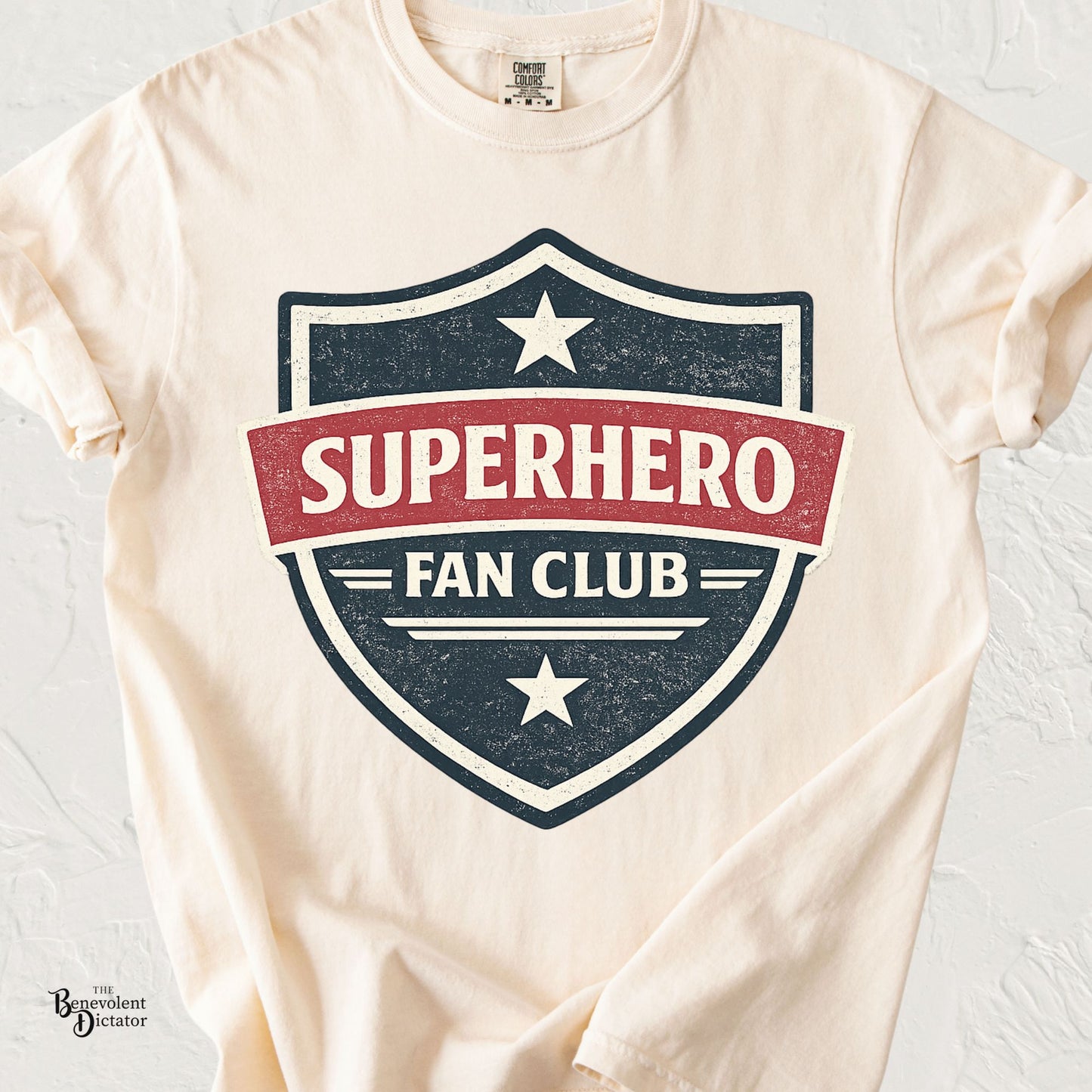 Vintage badge-style t-shirt featuring the phrase Superhero Fan Club in distressed comic-inspired lettering.