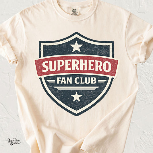 Vintage badge-style t-shirt featuring the phrase Superhero Fan Club in distressed comic-inspired lettering.