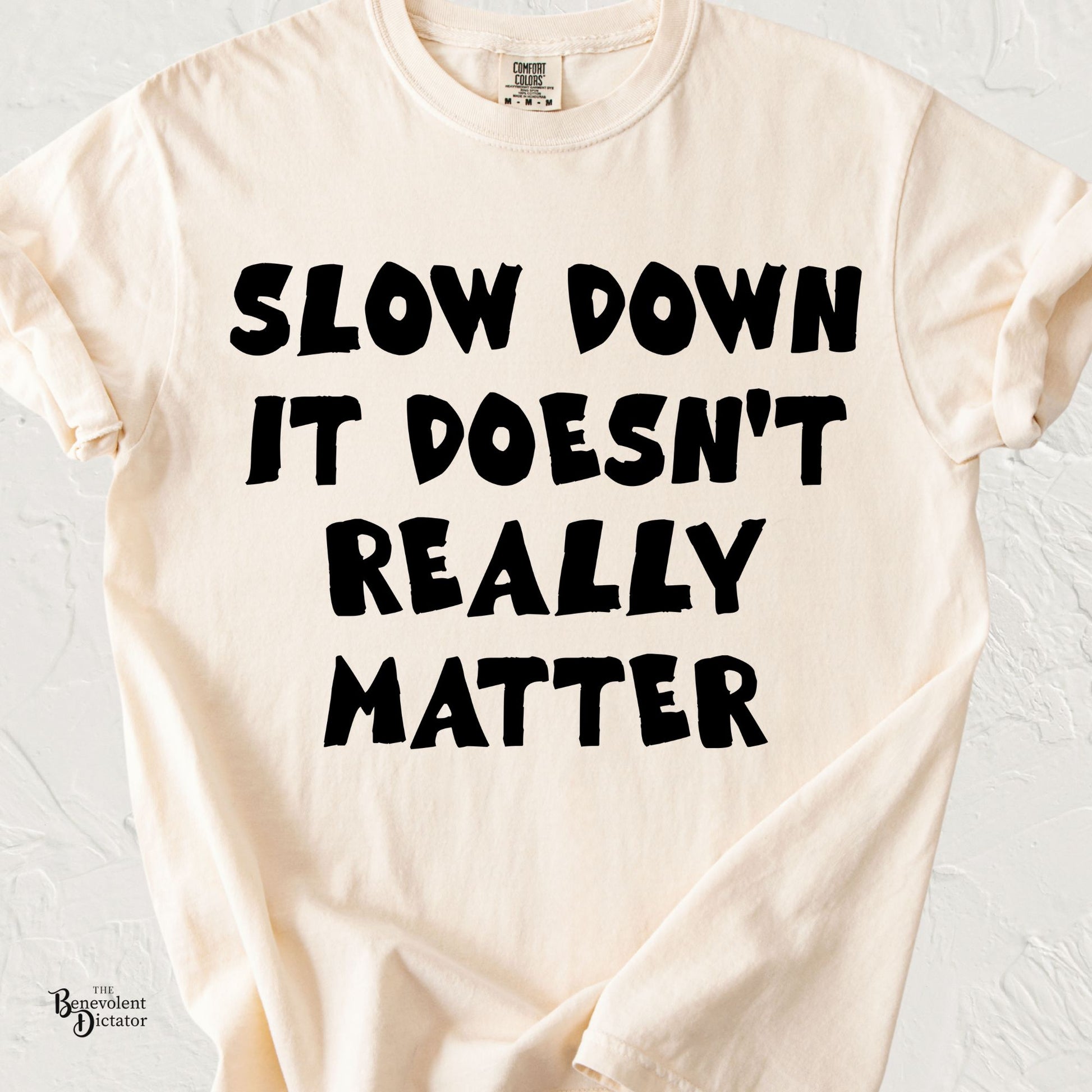 Typography t-shirt featuring the phrase Slow Down It Doesn’t Really Matter in bold minimalist lettering.
