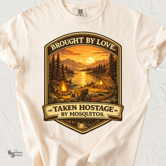 Vintage camping badge featuring a lakeside campsite at sunset with a tent, canoe, campfire, and the phrase "Brought by Love. Taken Hostage by Mosquitos."