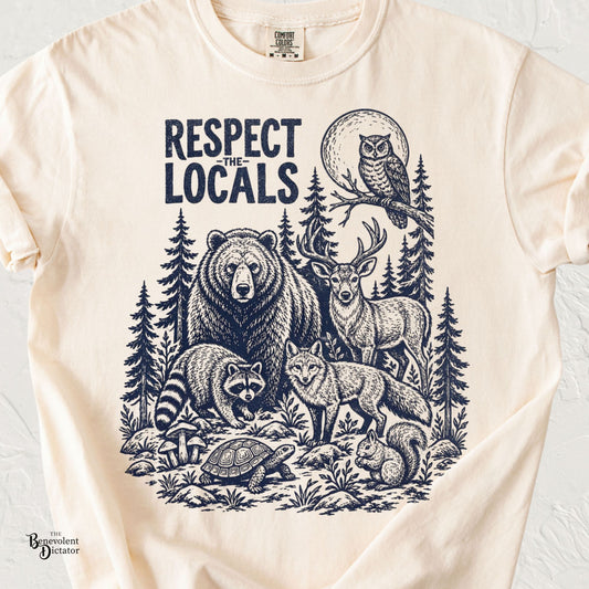 Respect the Locals wildlife t-shirt featuring a vintage navy illustration of a bear, deer, fox, raccoon, owl, turtle, squirrel, and forest landscape.