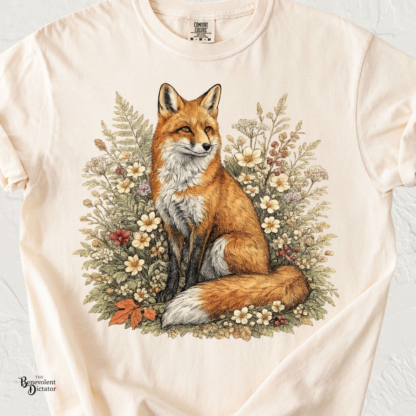 Vintage red fox t-shirt featuring a detailed fox surrounded by lush wildflowers, ferns, berries, and woodland foliage in muted earthy colors.
