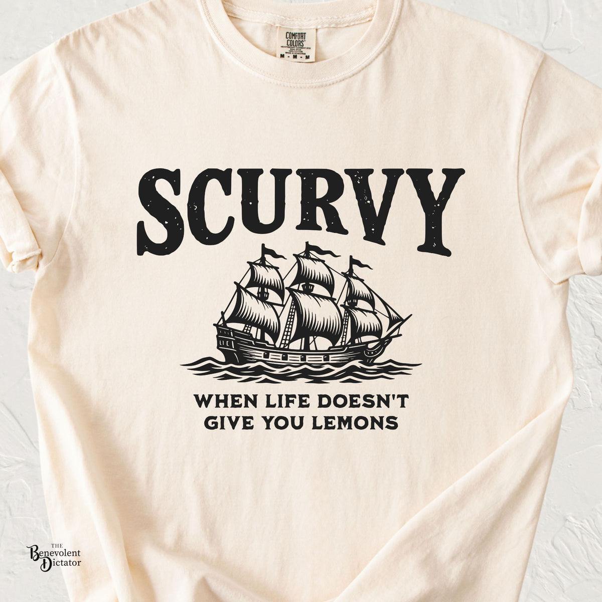 Ivory Comfort Colors t-shirt featuring a vintage black sailing ship with the word “Scurvy” and the phrase “When Life Doesn’t Give You Lemons.”