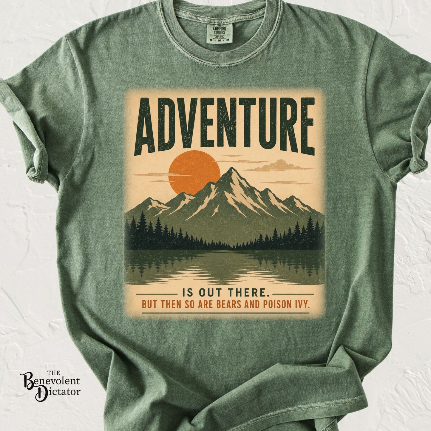Vintage outdoors graphic t-shirt featuring mountain landscape with sunset and text reading Adventure Is Out There… But Then So Are Bears and Poison Ivy.
