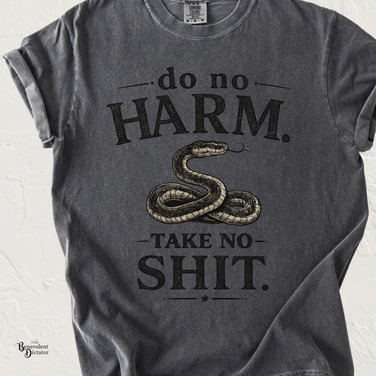 Black graphic t-shirt featuring vintage typography reading Do No Harm. Take No Shit. with an illustrated coiled snake in the center.