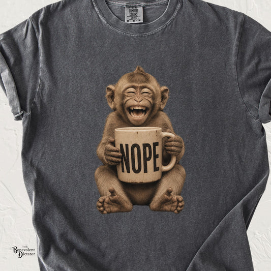 Funny laughing monkey holding a giant NOPE coffee mug graphic tee on a vintage washed shirt