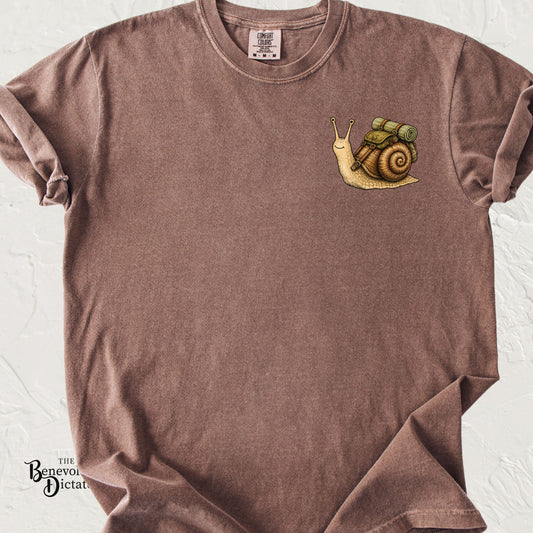 Cute hiking snail with a backpack and rolled sleeping pad on a minimalist left chest pocket design.