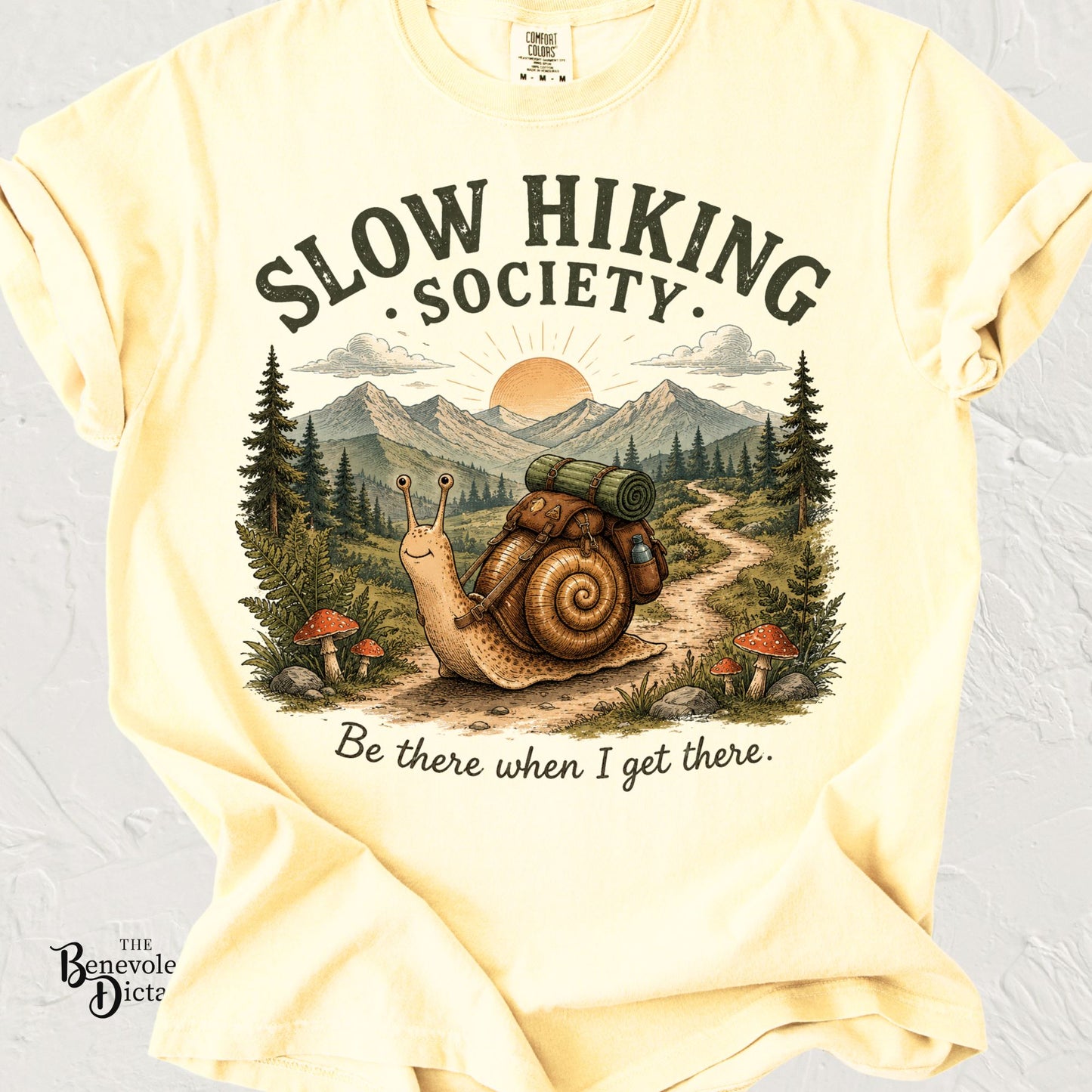 Vintage hiking snail wearing a backpack on a mountain trail with the phrase "Slow Hiking Society – Be there when I get there."