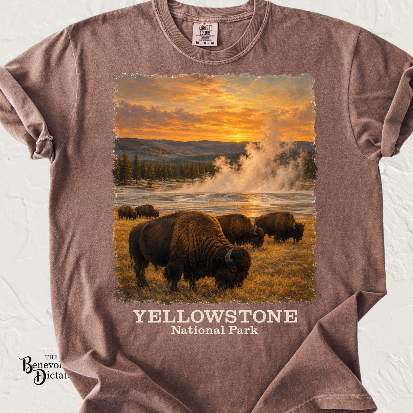 Vintage Yellowstone National Park shirt featuring grazing bison, steaming geyser and golden sunset on a Comfort Colors tee.